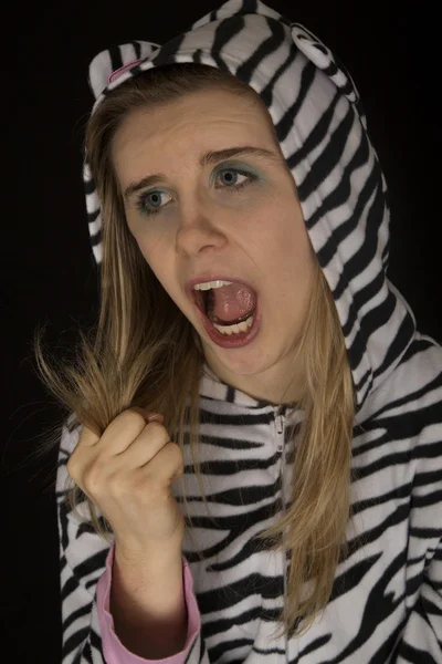 Woman wearing striped cat pajamas showing a fist closed roar — Stock Photo, Image