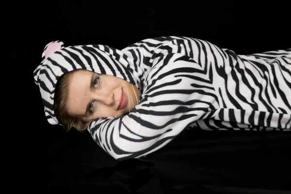 Woman wearing cat pajamas laying down and smiling Stock Image