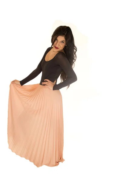 Pretty brunette female standing posing holding pink skirt — Stock Photo, Image
