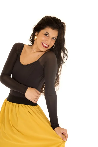 Pretty young woman wearing a black top and yellow skirt — Stock Photo, Image