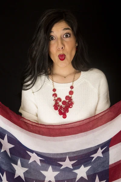 Beautiful woman with her lips puckered holding stars and stripes — Stock Photo, Image