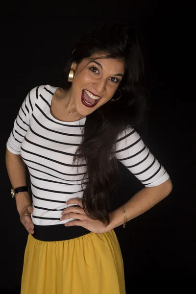 Attractive tan woman with a wide open smile wearing yellow skirt — Stock Photo, Image