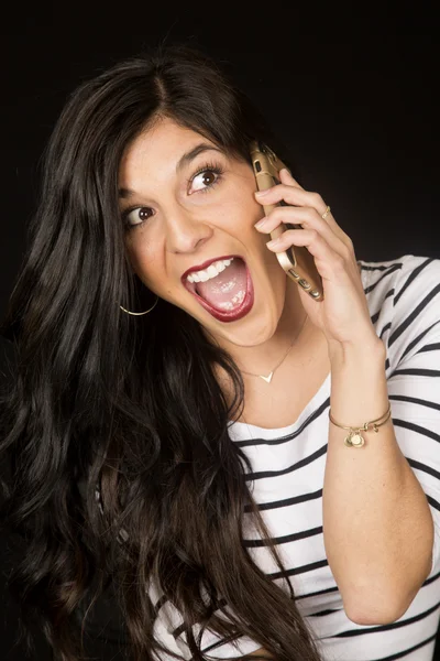 Excited beautiful brunette woman talking on her cell phone — Stock Photo, Image