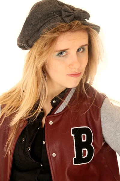 Girl wearing letterman jacket and hat with an attitude — Stock Photo, Image