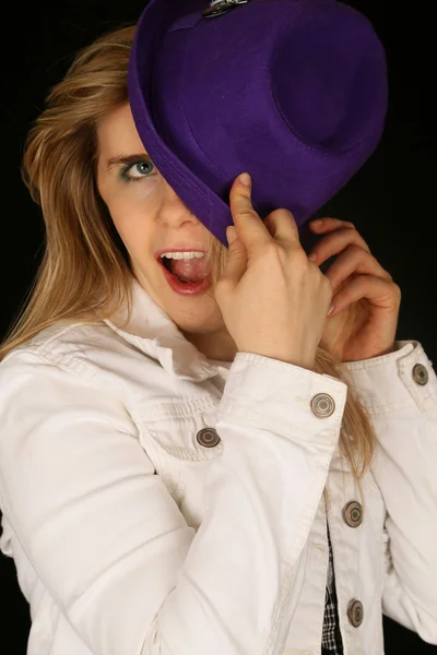 Woman wearing a purple hat hiding half of her face — Stock Photo, Image