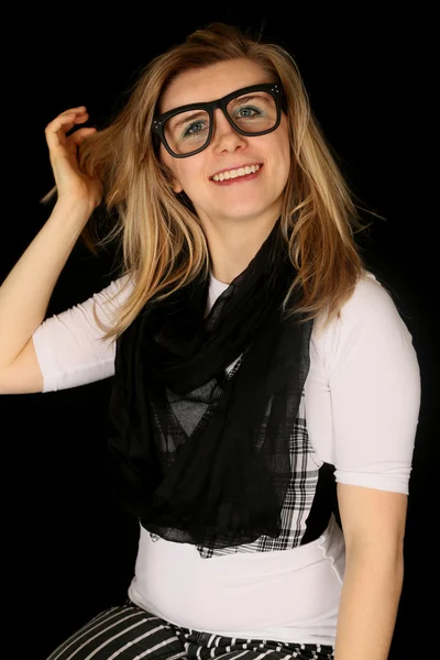 Girl wearing large black glasses smiling at the camera — Stock Photo, Image