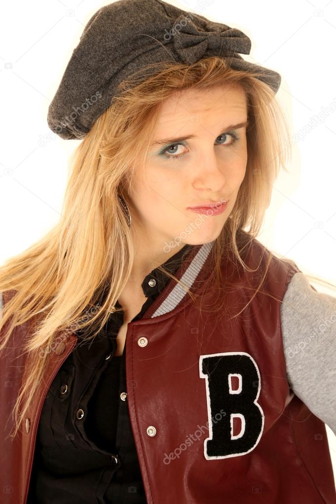 Girl wearing letterman jacket and hat with an attitude
