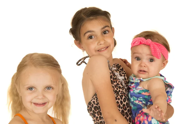 Three beautiful caucasian sisters standing wearing their swimsui — Stock Photo, Image