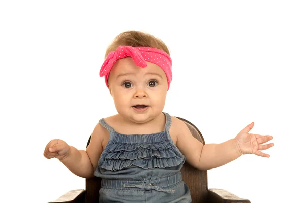 Cute baby girl sitting in a brown chair — Stock Photo, Image