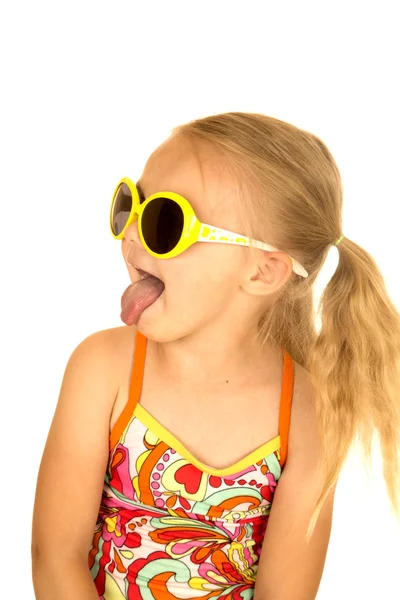 Menina loira engraçada usando óculos de sol língua saindo — Fotografia de Stock