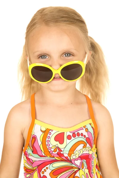 Silly blond girl wearing swimsuit and sunglasses down on nose — Stock Photo, Image
