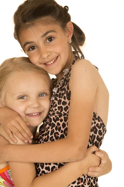 Beautiful young sisters wearing swimsuits hugging each other — Stock Photo, Image