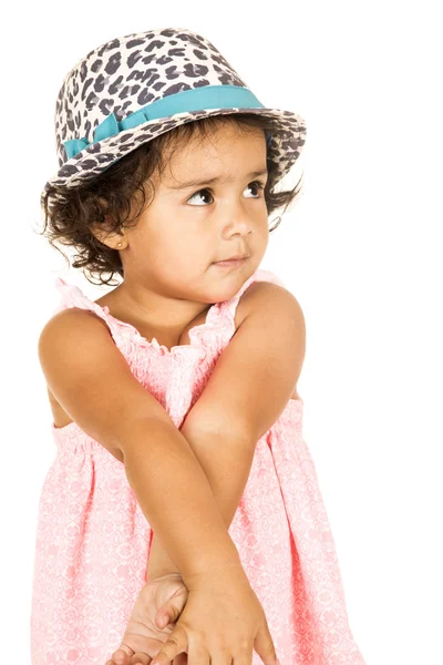Cute Hispanic toddler girl crossing arms wearing hat — Stock Photo, Image