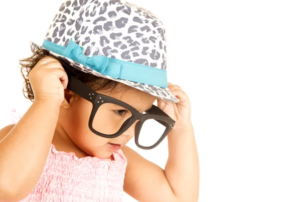 Funny Hispanic toddler girl playing with big black glasses — Stock Photo, Image