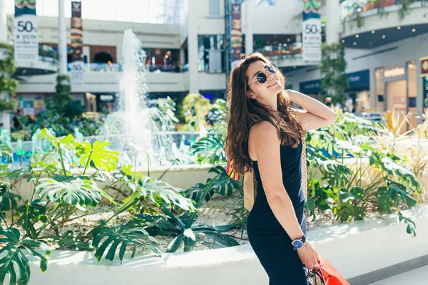 Cheerful Lady Stylish Black Dress Carrying Colorful Shopping Bags While — Stock Photo, Image