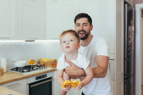 Padre Varón Sosteniendo Pequeño Hijo Sus Brazos Comiendo Cocinando Casa —  Fotos de Stock