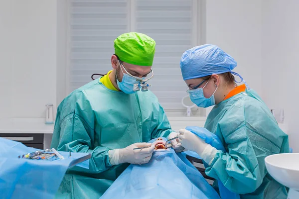 Equipo Cirujanos Dentales Realiza Cirugía Los Dientes Una Clínica Moderna — Foto de Stock