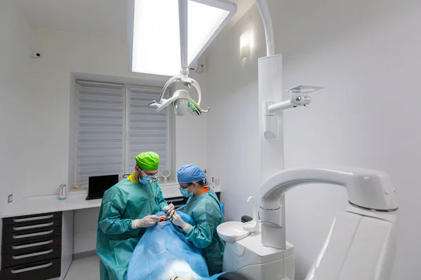 Team Dental Surgeons Performs Surgery Teeth Modern Clinic Young Dentist Stock Image