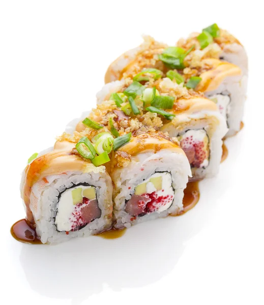 Sushi with shrimp avocado salmon and cheese strewed with green onion. Crunch Roll. With delicious sauces. On a plate over white background. — Stock Photo, Image