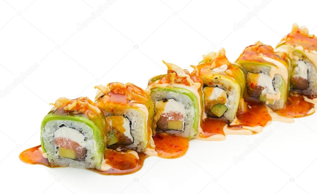 Sushi with avocado salmon and cheese. Crunch Roll. With delicious sauces. On a plate over white background.