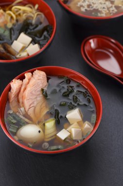 Japanese cuisine. Soup over black background. clipart