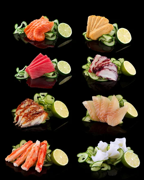 Sashimi set (salmon, tamago, tuna, octopus, eel, perch, shrimp) over black background — Stock Photo, Image