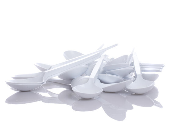 White plastic spoons isolated on white background