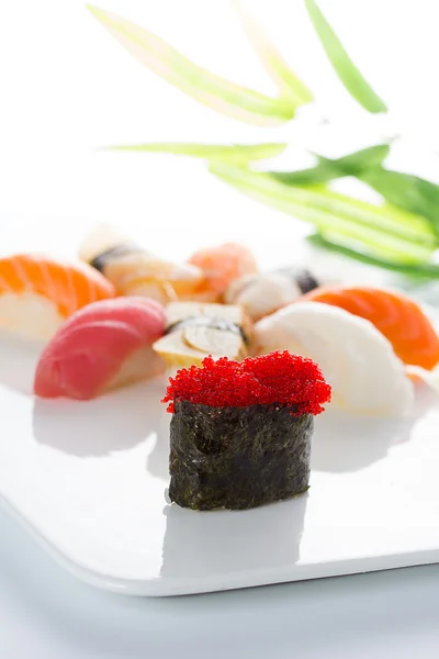 Sushi gunkan with black tobiko and nigiri on a white plate — Stock Photo, Image