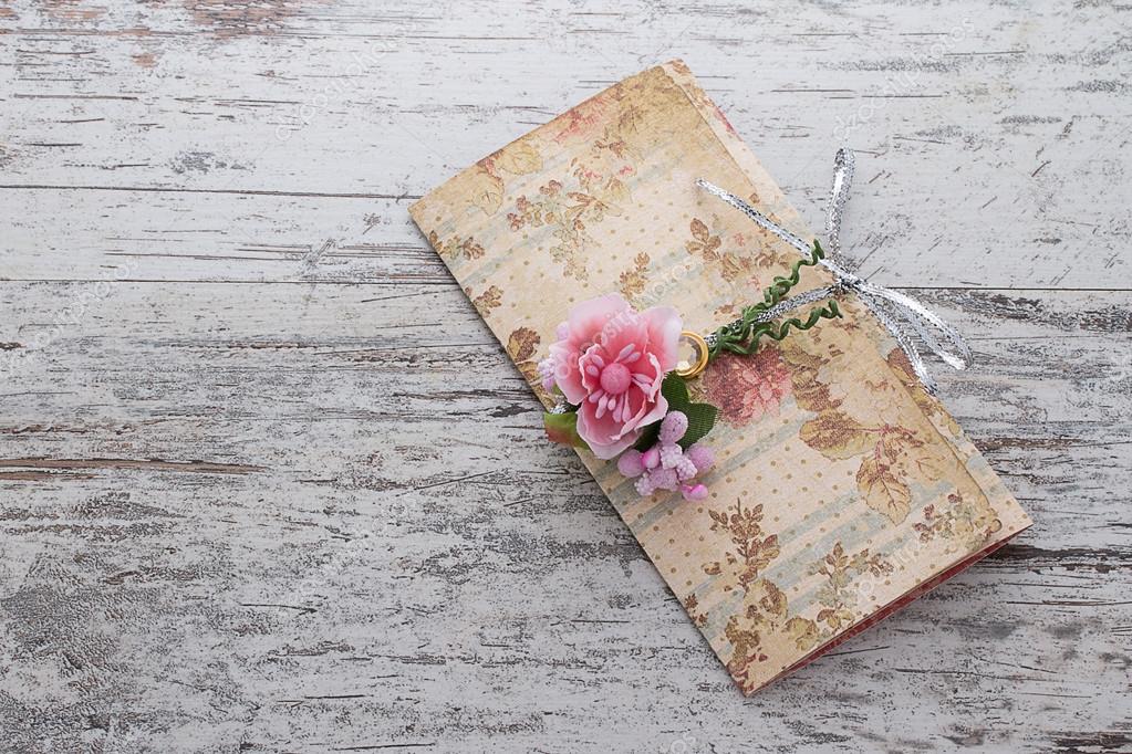 Handmade wedding invitations made of paper pver wooden vintage