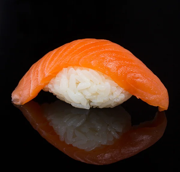 Salmão sushi nigiri sobre fundo preto com reflexão — Fotografia de Stock