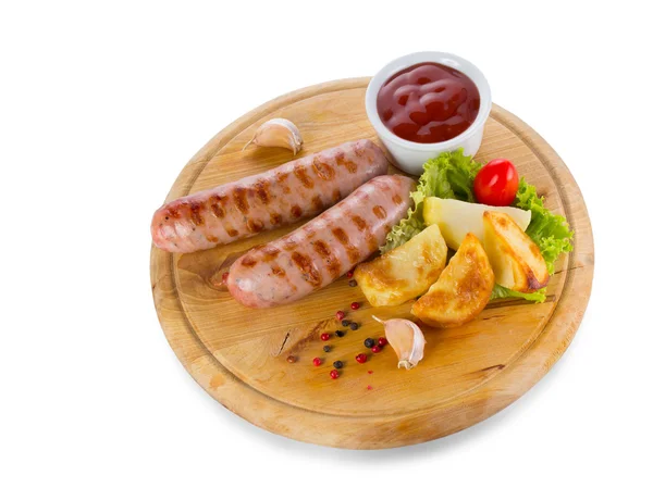 Tasty grilled sausages with vegetables and sauce close up — Stock Photo, Image