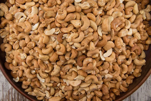 Raw cashews close-up in wooden bowl — Stock Photo, Image