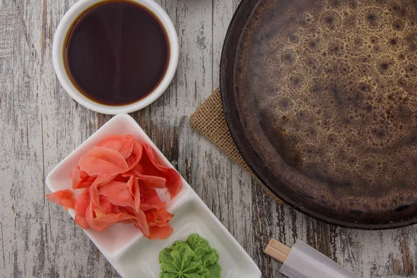 Pohled shora na prázdný talíř a sushi hůlkami na starý dřevěný stůl. — Stock fotografie