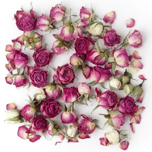 Decoratie gemaakt van gedroogde roze roos bloemen. Platte lay. — Stockfoto