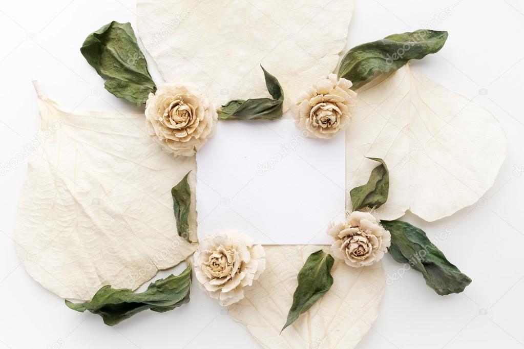 Framework with dry flowers on white background. Flat lay, overhead view