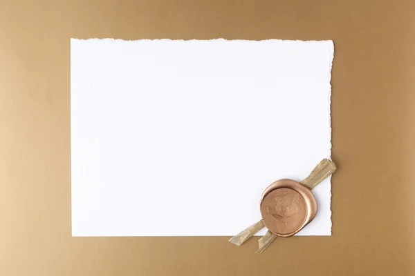 Letter wth wax seal on golden background. Flat lay. Top view