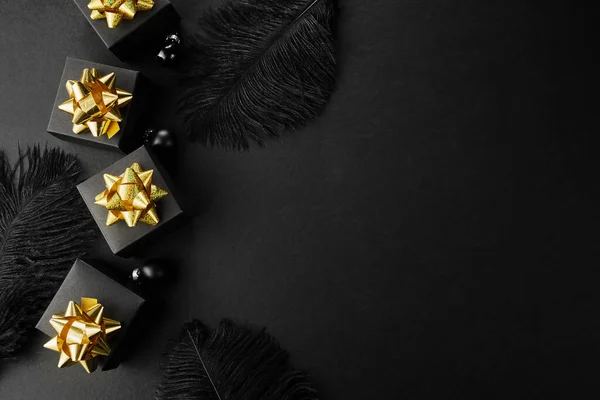 Black friday super sale background. Black gift boxes with golden ribbons and feathers — Stock Photo, Image