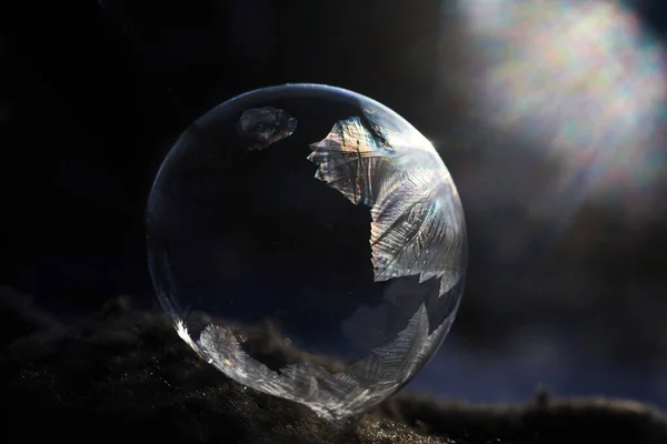 Frozen soap bubble with ice crystals at sunlight — Stock Photo, Image