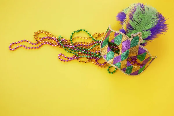 Mardi gras of carnaval masker met kralen op gele achtergrond. Venetiaans masker. — Stockfoto