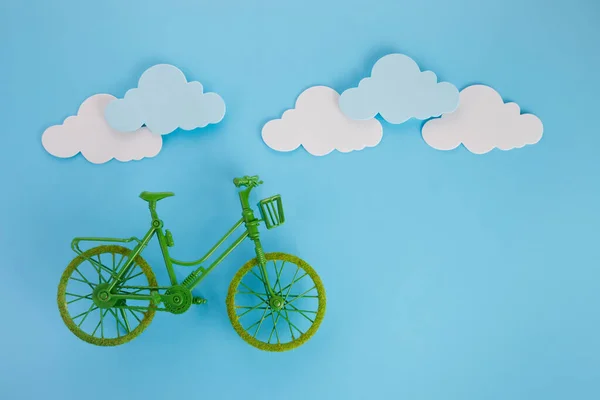 3rd June World Bicycle Day. Green bicycle on blue background. Environment preserve.