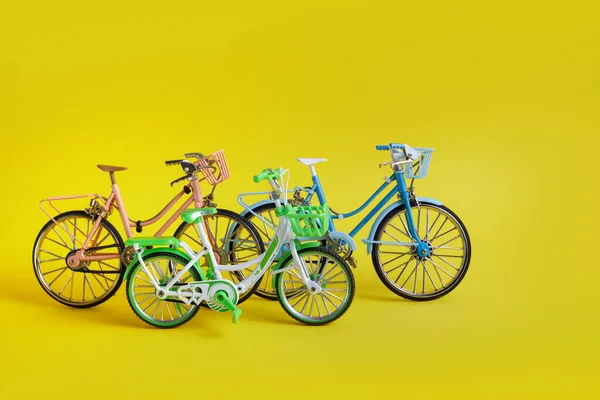3rd June World Bicycle Day. Family bicycles on yellow background. Environment preserve.