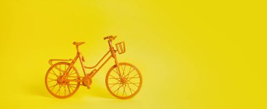 Sarı duvara park edilmiş klasik sarı bisiklet..