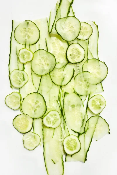 Fresh sliced transparent cucumber on white background. Flat lay. Top view — Stock Photo, Image