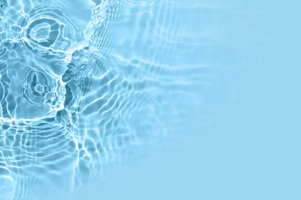 Blurred transparent blue colored clear water surface texture. Water waves in sunlight. Copy space — Stock Photo, Image