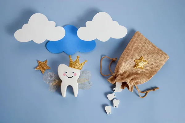 National Tooth Fairy Day. Children tooth fairy. Cute tooth with wings, a crown and a magic wand and bag with teeth. — Stock Photo, Image