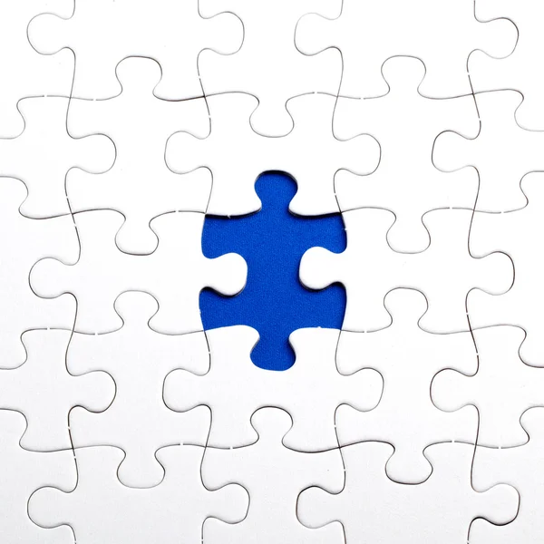 Plain white jigsaw puzzle, on Blue background — Stock Photo, Image