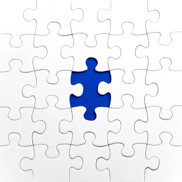 Plain white jigsaw puzzle, on Blue background — Stock Photo, Image