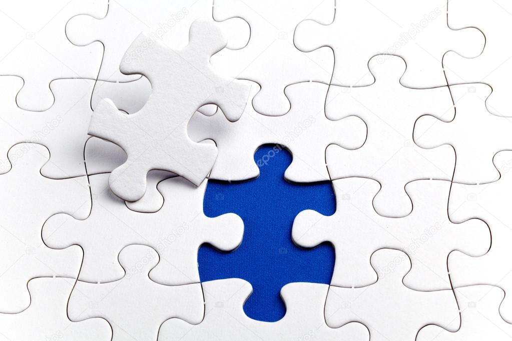 Plain white jigsaw puzzle, on Blue background