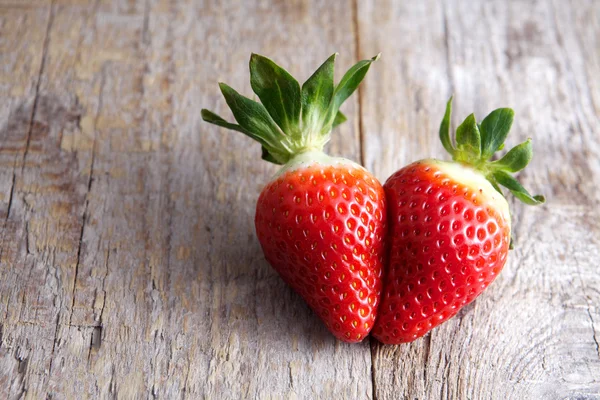 Strawberry heart-shaped on wood — Stock Photo, Image