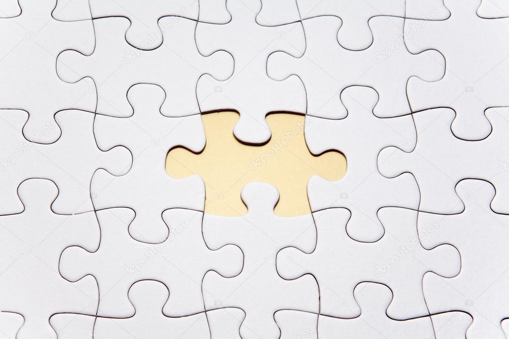 White puzzle shown with one piece missing 